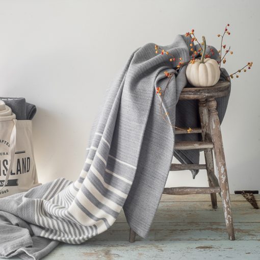 Swans Island's Penobscot Throw is woven in Maine with organic Merino wool and organic American Cotton. Shown here in Pewter with White.