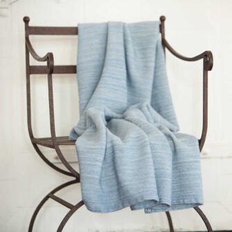 Swans Island's Acadia Throws are woven in Maine with organic Merino wool and organic American Cotton. Organic Washable Wool, extra soft. Shown in Wedgwood Blue.