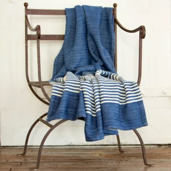 Swans Island's Penobscot Throw is woven in Maine with organic Merino wool and organic American Cotton. Shown here in nautical Blue with White.