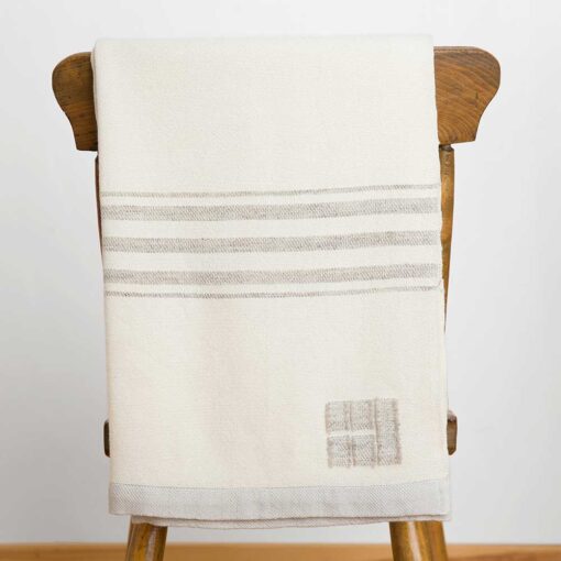Swans Island's Grace Throw. 100% organic merino wool handwoven in Maine. Shown in white with grey stripes