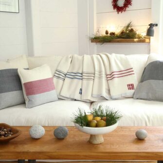 Swans Island's Grace Throw. 100% organic merino wool handwoven in Maine. Shown in white with multiple colors.
