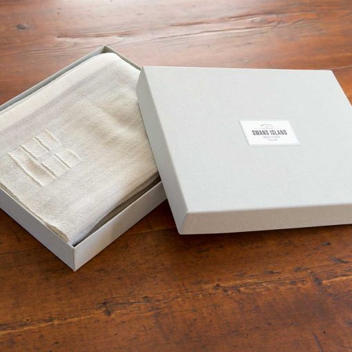 Swans Island handwoven wrap in custom grey linen gift box.