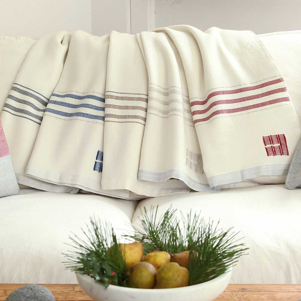 Swans Island Co. GraceThrows. Handwoven in Maine with classic striped borders. Soft organic merino wool throw.