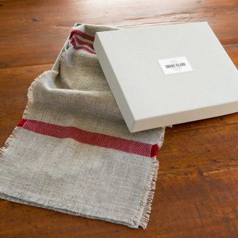 Swans Island handwoven scarf in custom grey linen gift box.