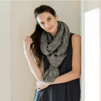 Swans Island Handwoven Firefly Wrap. Made in Maine with hand-dyed merino wool / silk yarn. Shown here in Onyx.