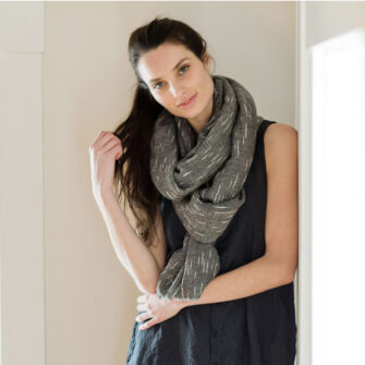 Swans Island Company's Handwoven Firefly Wrap. Made in Maine with hand-dyed merino wool / silk yarn. Shown here in Onyx.