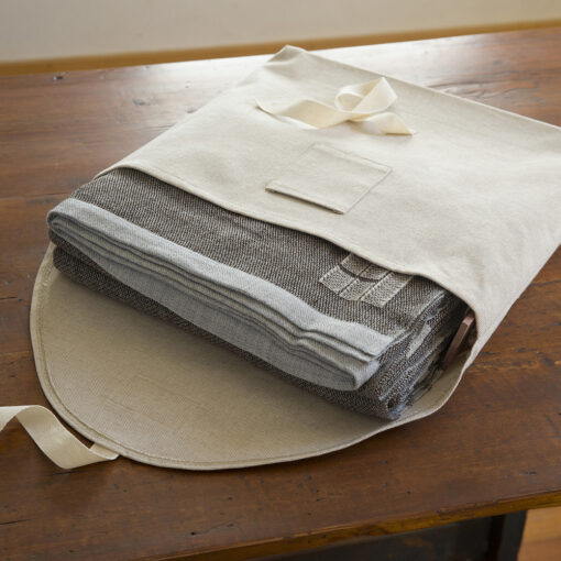 Swans Island's Island Blanket is handwoven in Maine and comes in this custom linen storage bag.