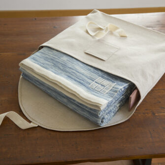 Swans Island handwoven Watercolors blanket comes in a custom linen storage bag with aromatic cedar slats.