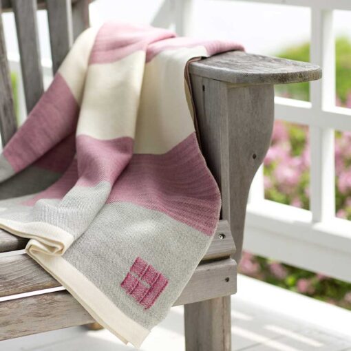 Swans Island Company - Made in Maine with hand-dyed merino wool. These beautiful throws are made with organic merino wool which is dyed with all-natural dyes. Shown here is the Maine Coast Throw in Raspberry.