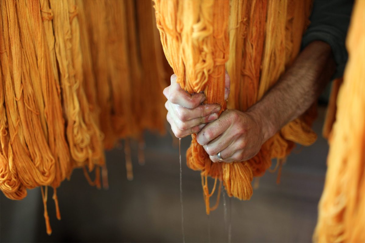 hands dipping yarn
