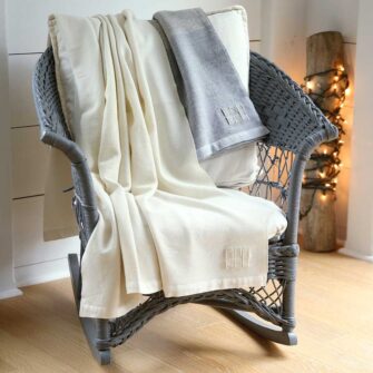 Swans Island Company's Solstice Throws are handwoven in Maine with undyed organic Merino wool and undyed corriedale wool. Shown here in white + white and grey + white