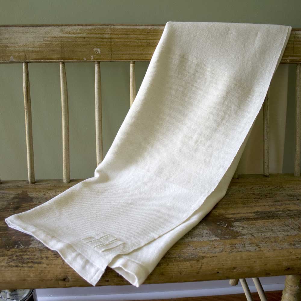 Swans Island Company's Solstice Throw is handwoven in Maine with undyed organic Merino wool and undyed corriedale wool. Shown here in white + white