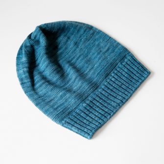 Swans Island Company's Bar Island Hat is knit with soft silk and merino wool. Shown in mallard. 100% made in USA with hand-dyed yarns.