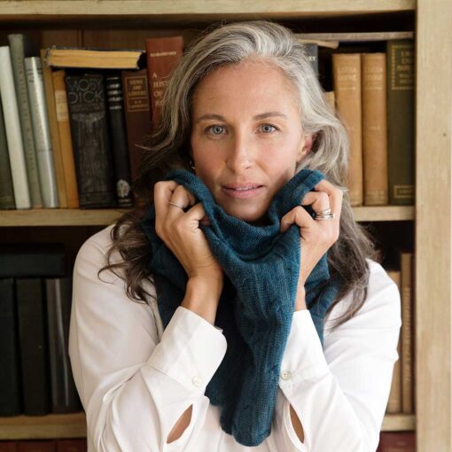 Swans Island Company's Cirrus Cowl is knit with shimmery hand-dyed silk and merino wool. Made in USA. Shown with silver-haired model wearing cowl in Mallard.