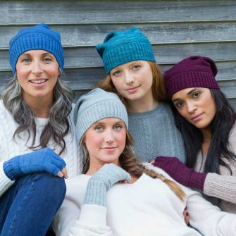 Swans Island Company's Bar Island Hat is knit with soft silk and merino wool. Shown in assorted colors with matching fingerless mitts. 100% made in USA with hand-dyed yarns.