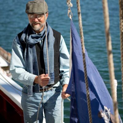 Swans Island Company's Camden Scarf is handwoven in Maine. Hand-dyed wool yarn gives each scarf one-of-a-kind flair. This unisex design makes a great gift for everyone. Shown here in indigo.
