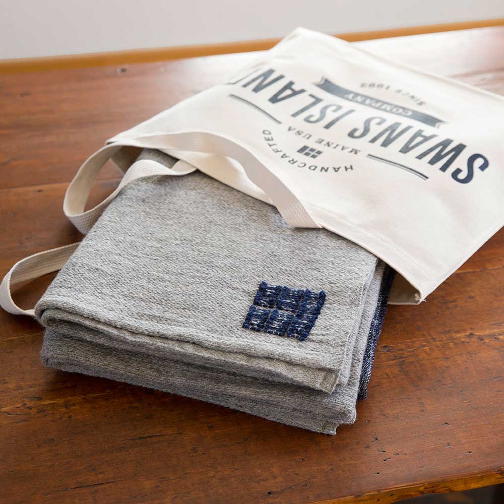 Each Swans Island Mt. Kineo Throw is handwoven in Maine with American Rambouillet wool and alpaca and comes in a handy canvas tote.