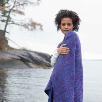 Swans Island Watercolors Cape is handwoven in Maine using our unique hand-dyed yarn. We dye our own yarns using all natural dyes on soft organic merino wool. Indigo/Beetroot colorway.