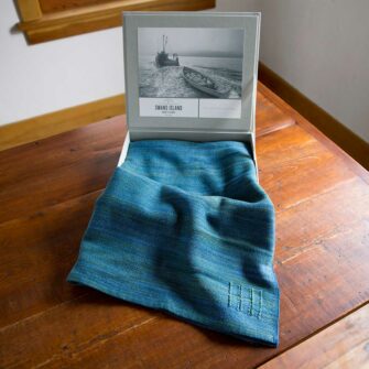 Swans-Island company's Watercolors-Cape in linen gift box. Shown here in Indigo / teal color.