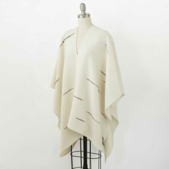 Swans Island's Whitecaps Cape, handwoven in Maine with hand-dyed organic merino wool. Natural with Charcoal colorway.