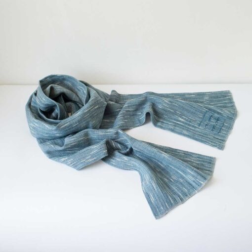 Swans Island Company's Firefly Scarf is handwoven in Maine with uniquely hand-dyed yarn. Soft organic merino wool has flecks of white reminiscent of fireflies twinkling against a night sky. Shown here in Teal.