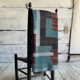 Swans Island's Artisan Patchwork Throw #215 is a one-of-a-kind knit. Made in USA this cozy oversized throw has richly marled yarns. Each one is unique.