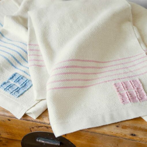 Stillwater Ranch x Swans Island Baby Blanket - Ltd. Edition. A collaboration with Chris Pratt and Katherine Schwarzenegger's ranch and Swans Island Co. Kid mohair from Stillwater Ranch is blended with other fine fibers, spun, hand-dyed, handwoven in Maine. Natural with Rose Quartz or Sky Blue stripes.