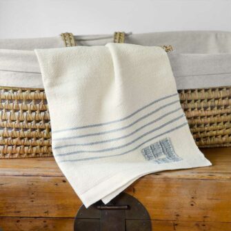 Stillwater Ranch x Swans Island Baby Blanket - Ltd. Edition. A collaboration with Chris Pratt and Katherine Schwarzenegger's ranch and Swans Island Co. Kid mohair from Stillwater Ranch is blended with other fine fibers, spun, hand-dyed, handwoven in Maine. Natural with Pewter Stripes.