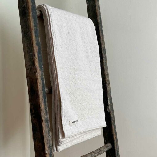 Swans Island's beautifully textured Bedford Blanket is woven in Maine in undyed natural cotton.