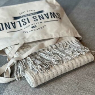 Swans Island's Cotton Ticking Throw Fringe blanket is woven in Maine with 100% American cotton.