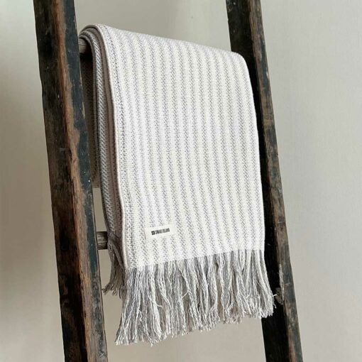Swans Island's Cotton Ticking Throw Fringe blanket is woven in Maine with 100% American cotton.