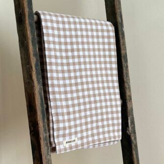 Swans Island's classic Gingham Check Throw blanket is woven in Maine with 100% natural cotton.