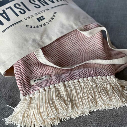 Swans Island's Savannah Throw blanket is woven in Maine with 100% American cotton and features a hand-tied fringe.