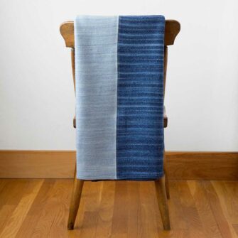 Swans Island's Acadia Patchwork Throw. Upcycled organic merino wool and cotton, made in Maine USA. Wedgwood/Nautical Blue/Wedgwood Colorway.