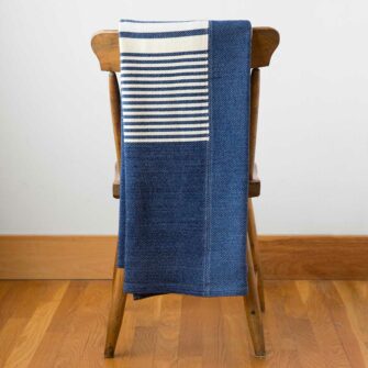 Swans Island's Up-cycled Penobscot Patchwork Throw. Upcycled organic merino wool and cotton, made in Maine USA. Nautical Blue + White Colorway.