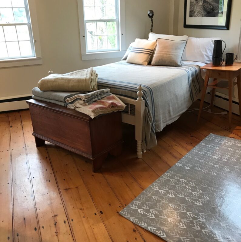 The front room of Swans Island's 1790 farmhouse in Northport, Maine showcases blankets and other handcrafted products made in the next room.
