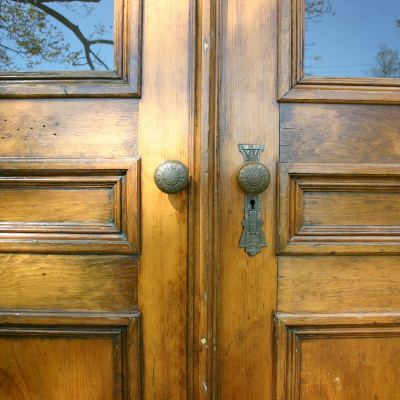 Antique doors welcome visitors to the Swans Island Company Northport showroom, shop and weaving studio.