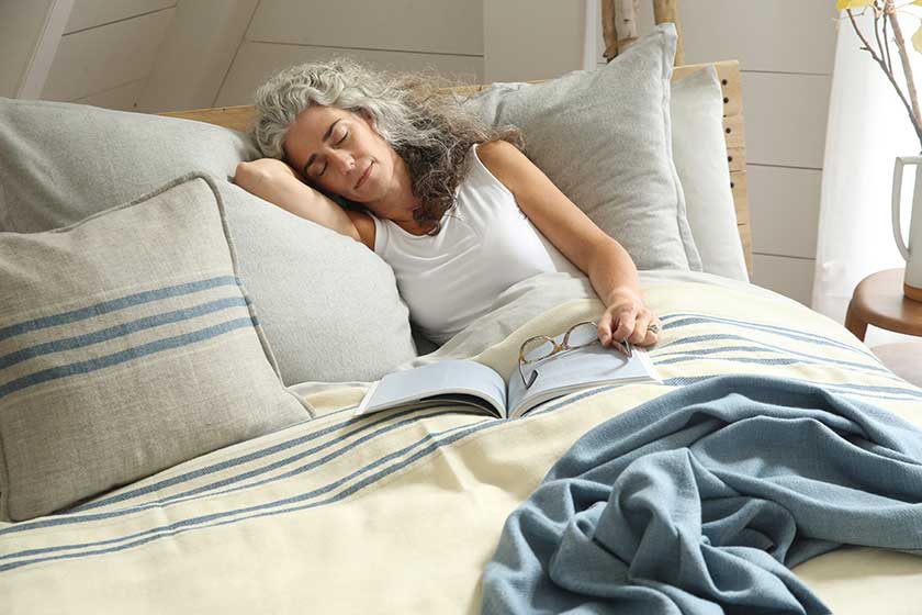 woman asleep under heritage blanket