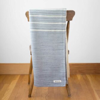 Swans Island Company - Breakwater Throw - made in Maine with soft organic merino wool and cotton. Shown in Pewter + Natural stripe.