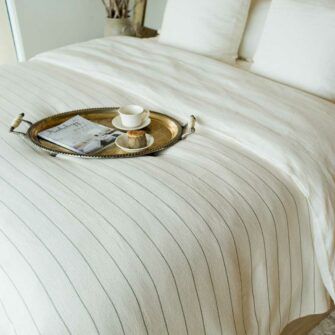 Swans Island Cotton Pinstripe Blanket made in Maine with soft 100% American cotton. Natural + Flax stripe.