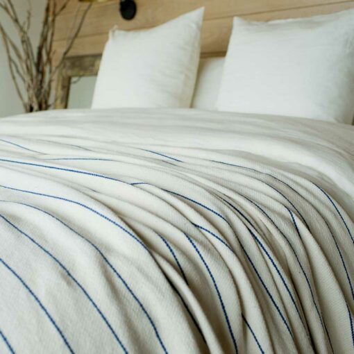 Swans Island Cotton Pinstripe Blanket made in Maine with soft 100% American cotton. Natural + Ink Blue stripe.