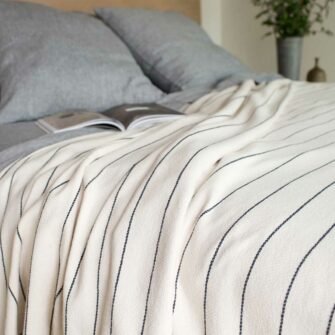 Swans Island Cotton Pinstripe Blanket made in Maine with soft 100% American cotton. Natural + Slate Grey stripe.