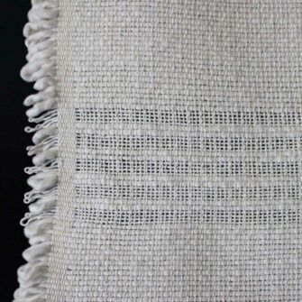 Swans Island - Poyvi Throw by Under the Bough, rustic cotton handwoven in Paraguay. Shown in Natural.