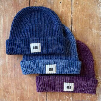 Swans Island Fisherman's Beanie - Knit in USA with soft, hand-dyed silk merino wool shown in Midnight, Nautical Blue, Plum.