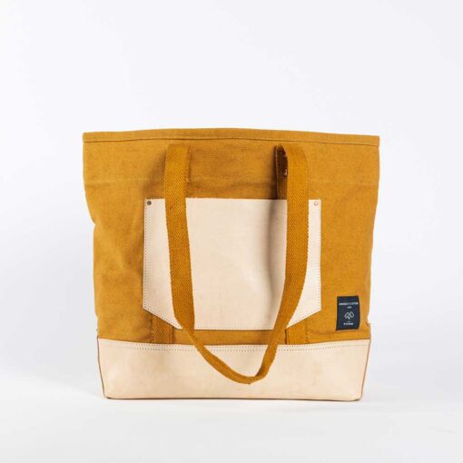 Swans Island Company's Canvas Bucket Tote in heavy cotton canvas with leather bottom and pocket, removable leather handles, and cotton webbing shoulder straps - by Immodest Cotton. Mustard Seed