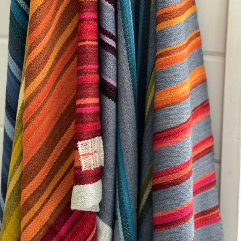 Swans Island Company's Limited Edition Prism Series Throws. Nine rainbow-inspired throws designed by our team of talented weavers. Each throw in this limited edition drop is unique!. An array of beautiful finished Prism Throws await their new homes.