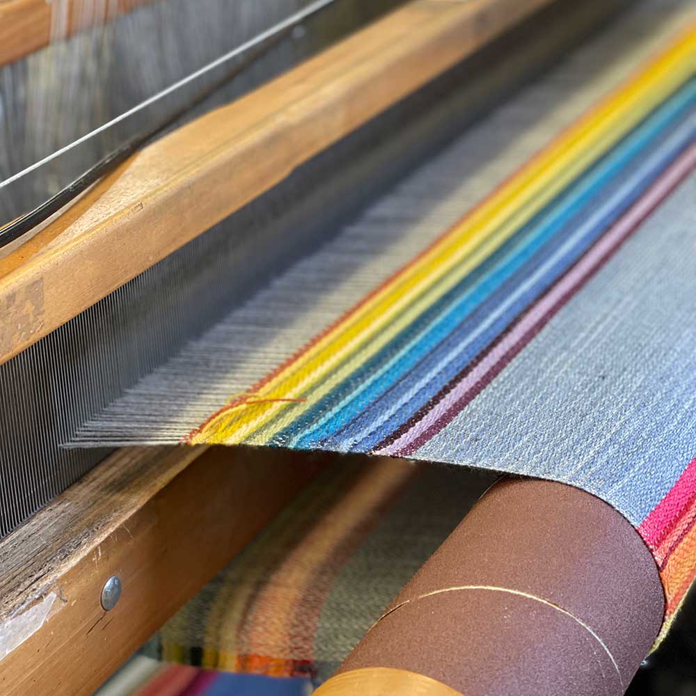 Swans Island Company's Limited Edition Prism Series. Nine rainbow-inspired throws designed by our team of talented weavers. Each throw in this limited edition drop is unique! A rainbow of wool colors is on the loom.