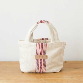 Swans Island's Mini Beach Tote - made by Govou from up-cycled vintage European grain sacks. Shown here in Natural with Black stripes and Natural with Red and Blue stripes.