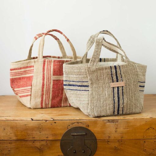 Swans Island's Beach Tote - made by Govou from up-cycled vintage European grain sacks. Shown here in Natural with Black stripes and Natural with Red stripes.