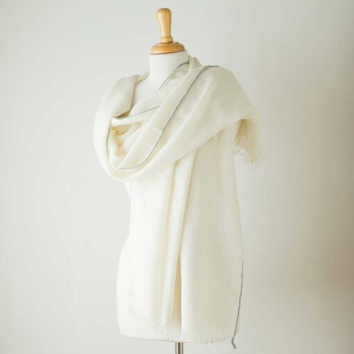Swans Island Company's Alpaca Whisper Shawl - handwoven in Peru with the softest baby alpaca. Airy and light yet worm with an unexpected pop of color along the edge. Shown here in Ivory with Wedgwood edge.
